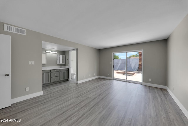 unfurnished living room with light wood-type flooring