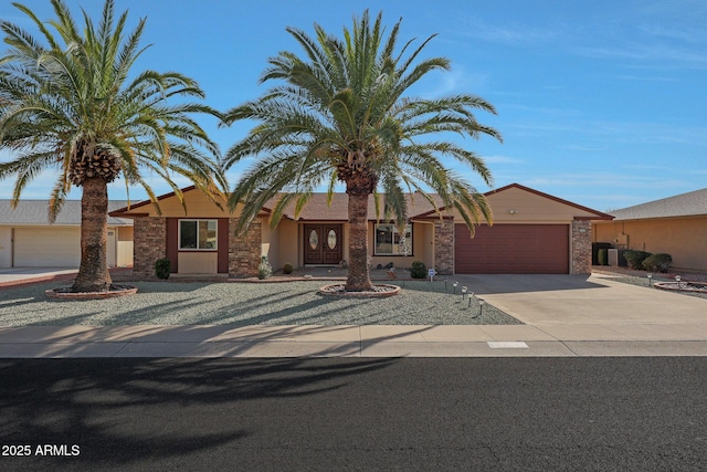 view of front of property featuring concrete driveway and an attached garage