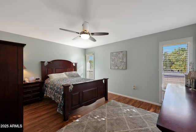 bedroom with a ceiling fan, baseboards, and wood finished floors