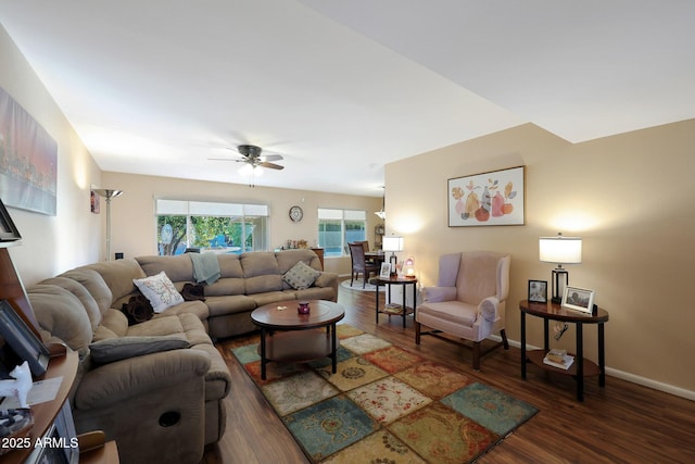 living area with wood finished floors, a ceiling fan, and baseboards