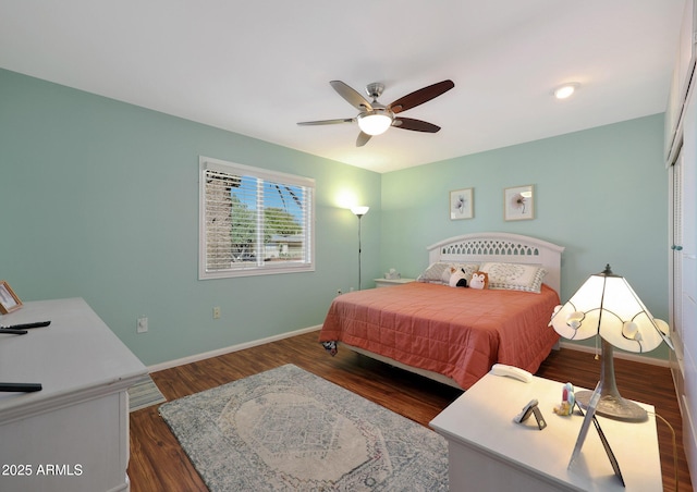 bedroom with a ceiling fan, baseboards, and wood finished floors