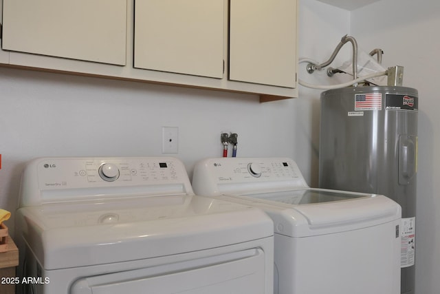 laundry room featuring washer and dryer, cabinet space, and water heater