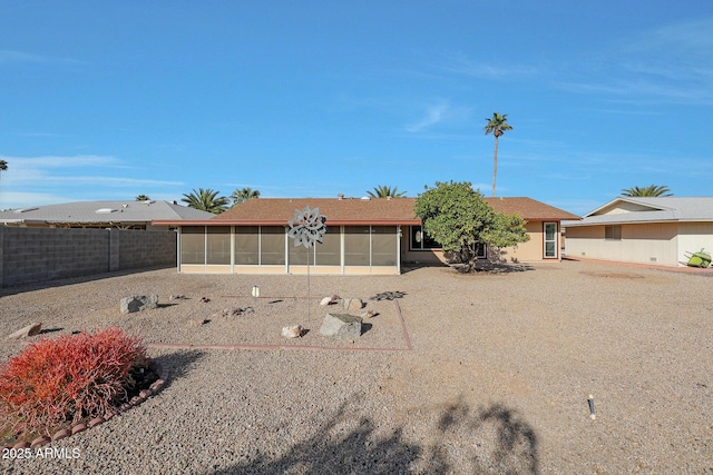 ranch-style house featuring fence and a sunroom