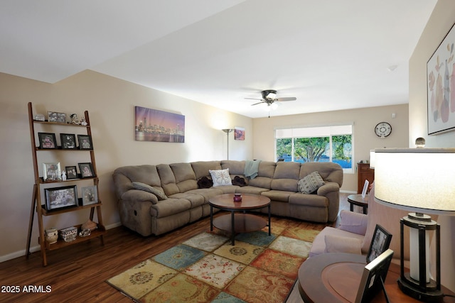 living room with ceiling fan, baseboards, and wood finished floors