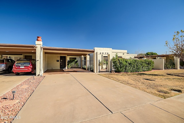 pueblo-style house featuring a carport