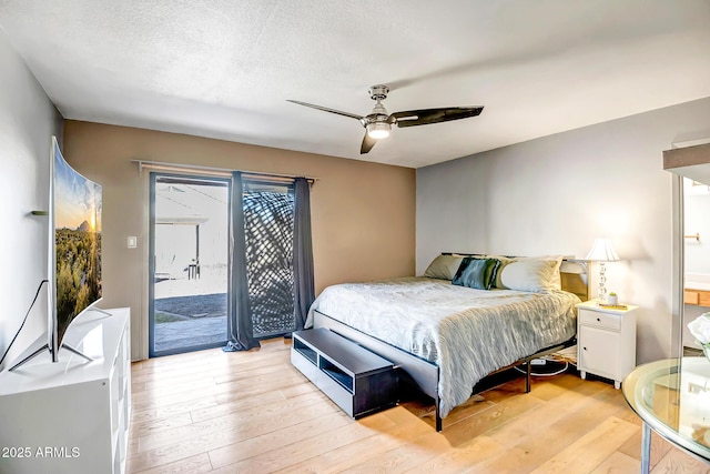 bedroom featuring access to exterior, a textured ceiling, light hardwood / wood-style flooring, and ceiling fan