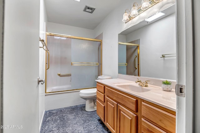 full bathroom featuring vanity, shower / bath combination with glass door, and toilet