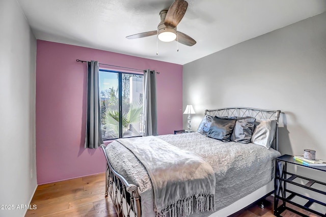 bedroom with hardwood / wood-style floors and ceiling fan