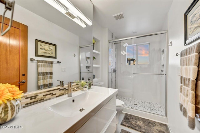 full bathroom with toilet, vanity, visible vents, tasteful backsplash, and a stall shower