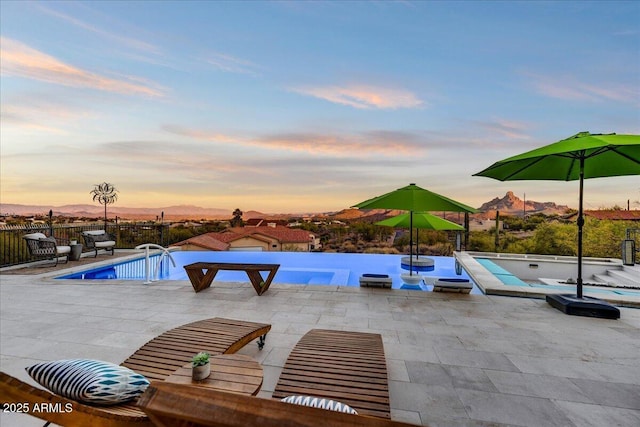 view of swimming pool with a patio, fence, and a fenced in pool