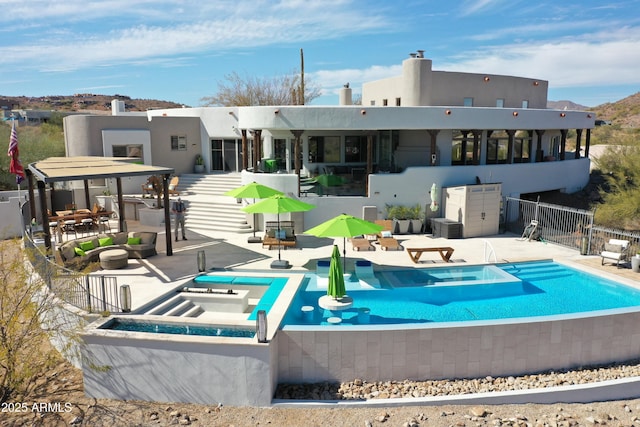 back of house with a patio area, fence, a community pool, and stucco siding