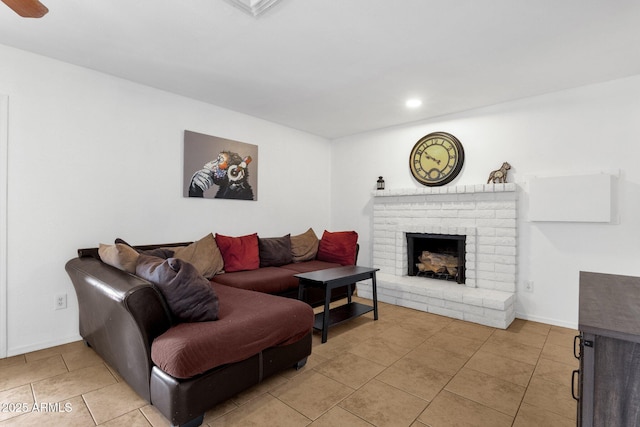 living area featuring a fireplace, light tile patterned floors, baseboards, and recessed lighting