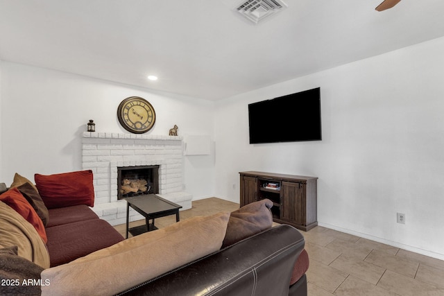 living area with baseboards, a ceiling fan, a fireplace, tile patterned floors, and recessed lighting