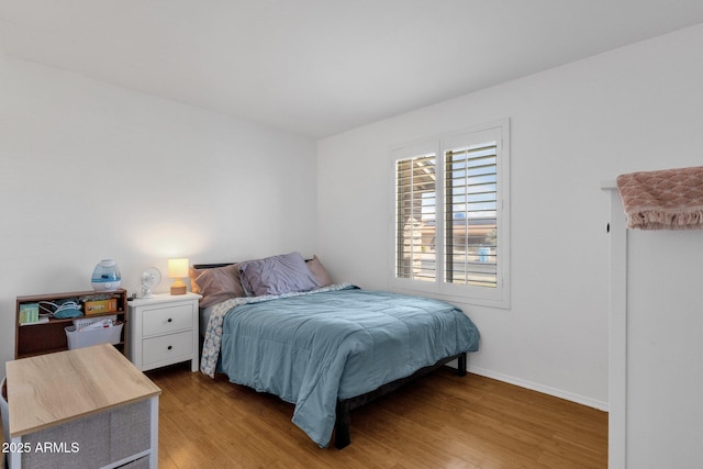 bedroom with wood finished floors and baseboards