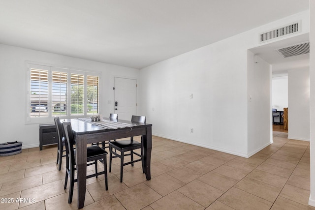 dining area featuring light tile patterned floors and baseboards