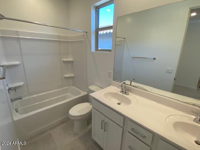 full bathroom featuring toilet, shower / tub combination, vanity, and tile patterned flooring