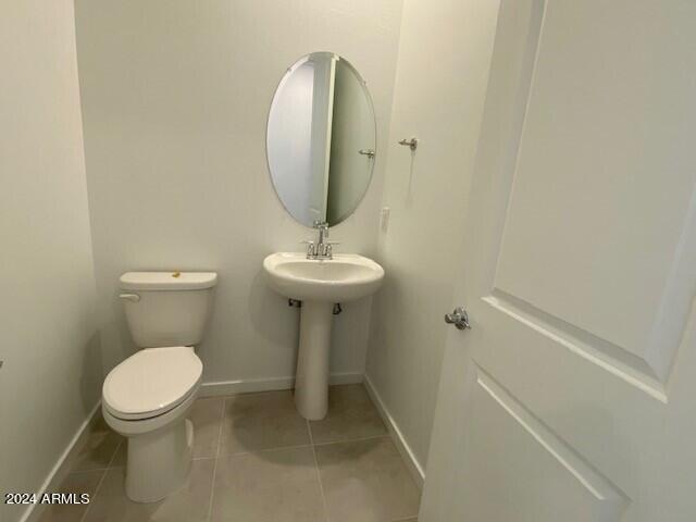 bathroom with toilet and tile patterned floors