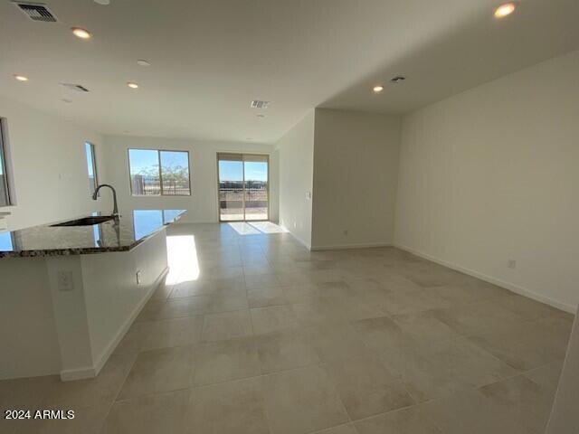 interior space with light tile patterned floors and sink