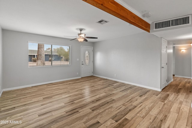 empty room with beamed ceiling, ceiling fan, and light wood-type flooring