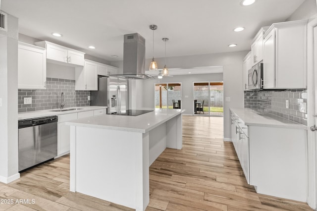 kitchen with white cabinetry, pendant lighting, stainless steel appliances, and island range hood