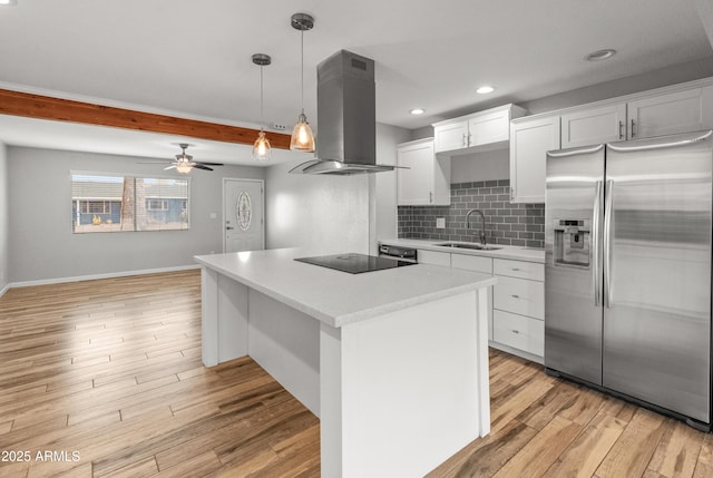 kitchen with white cabinetry, sink, stainless steel fridge, black electric cooktop, and island range hood