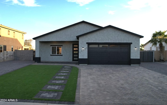 view of front of house featuring a garage and a front yard