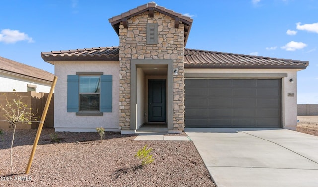 mediterranean / spanish home featuring fence, a tiled roof, concrete driveway, stucco siding, and an attached garage