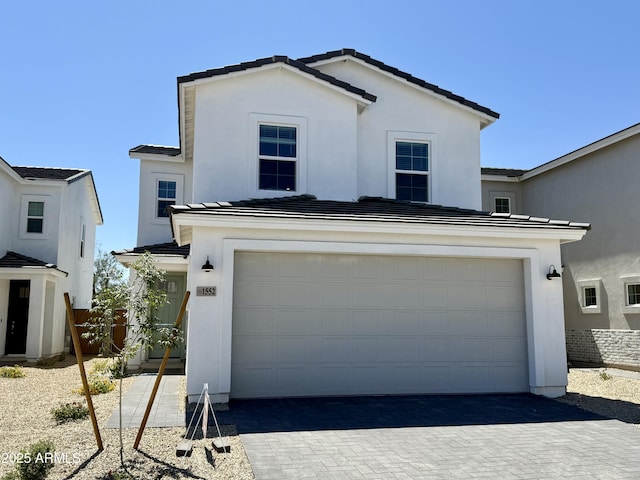1552 N Pueblo Dr, Apache Junction, AZ 85120 - view of front of home with stucco siding, driveway, an attached garage, and a tile roof