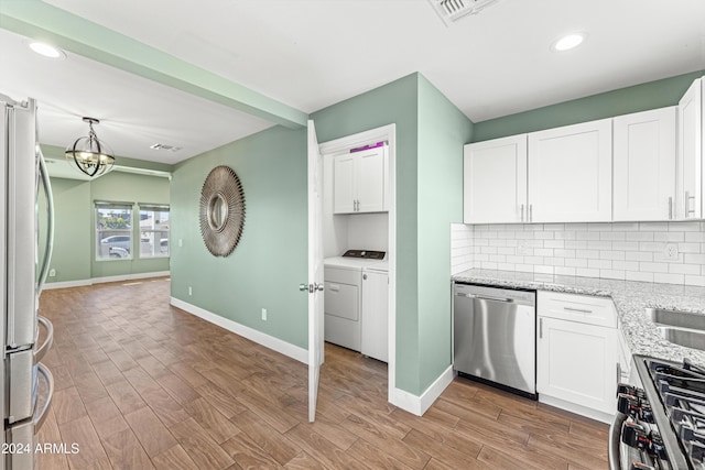 kitchen featuring light hardwood / wood-style floors, light stone counters, white cabinetry, and stainless steel appliances