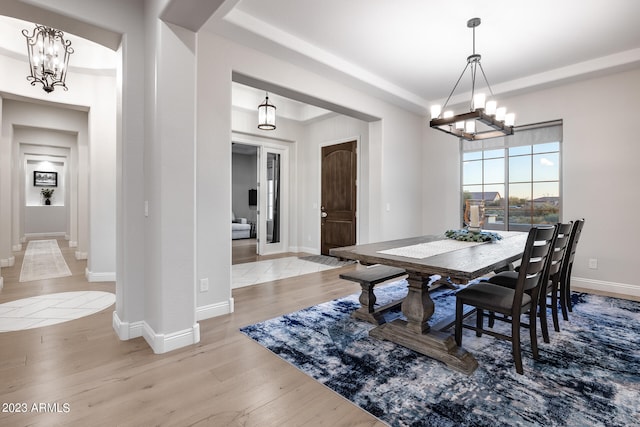 dining room featuring a notable chandelier and light hardwood / wood-style flooring