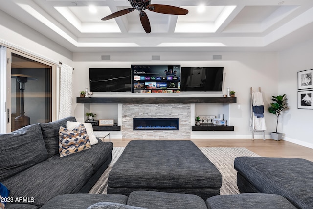 living room with ceiling fan, light wood-type flooring, and a fireplace