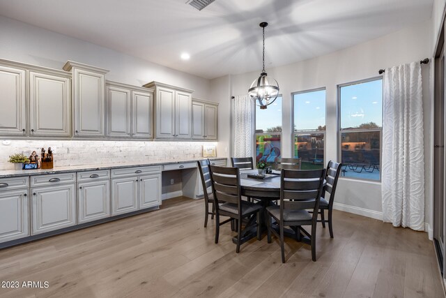 dining area with a notable chandelier and light wood-type flooring