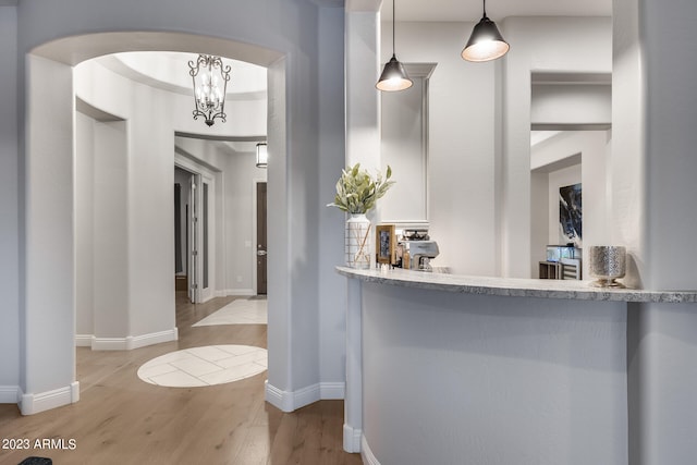 interior space with light hardwood / wood-style floors and an inviting chandelier