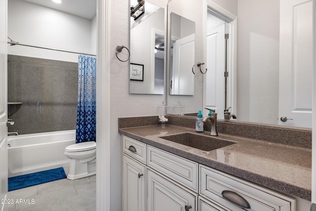 full bathroom with toilet, shower / bath combo, vanity, and tile patterned floors