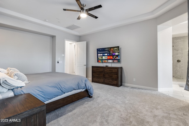 carpeted bedroom with ceiling fan and ensuite bathroom