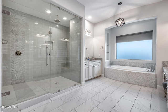 bathroom featuring plus walk in shower and vanity