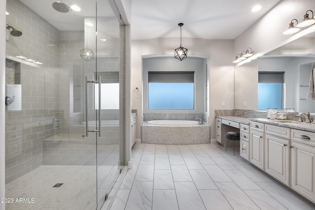 bathroom with vanity and shower with separate bathtub