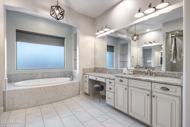 bathroom with vanity and tiled tub