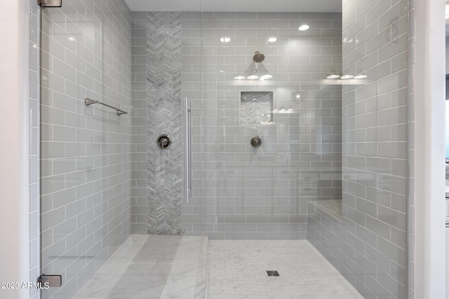 bathroom with a tile shower