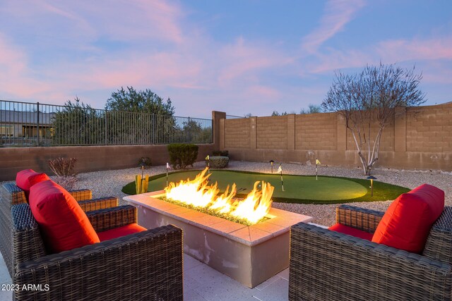 patio terrace at dusk with a fire pit