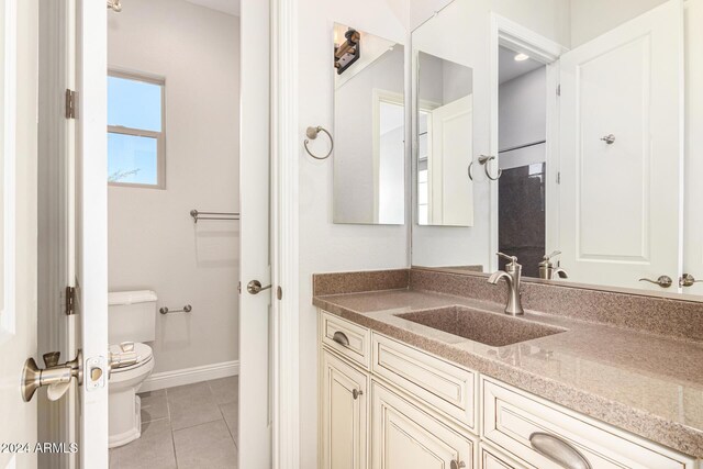 bathroom featuring tile patterned flooring, vanity, and toilet