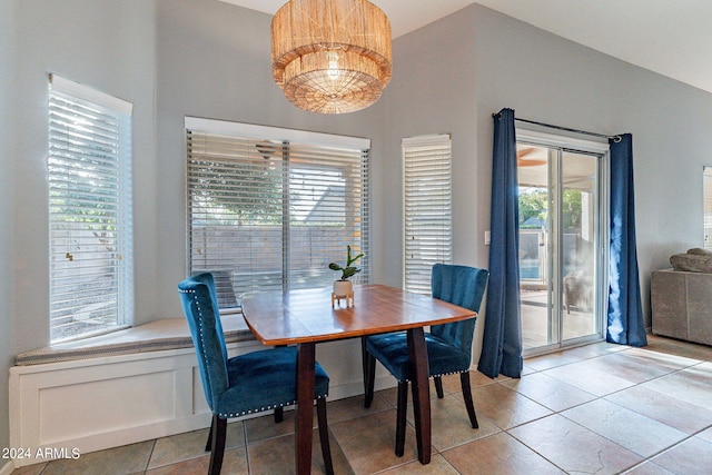 dining space with vaulted ceiling and light tile patterned floors