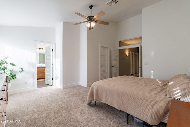 bedroom featuring baseboards, visible vents, carpet floors, high vaulted ceiling, and ensuite bath