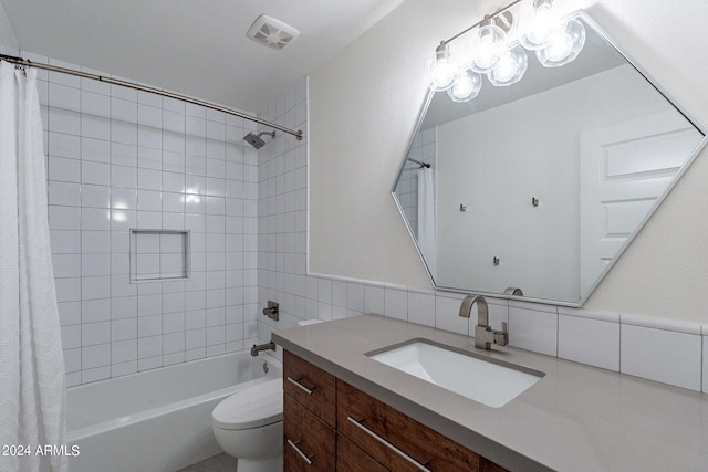 full bathroom with tile walls, shower / tub combo with curtain, toilet, vanity, and decorative backsplash