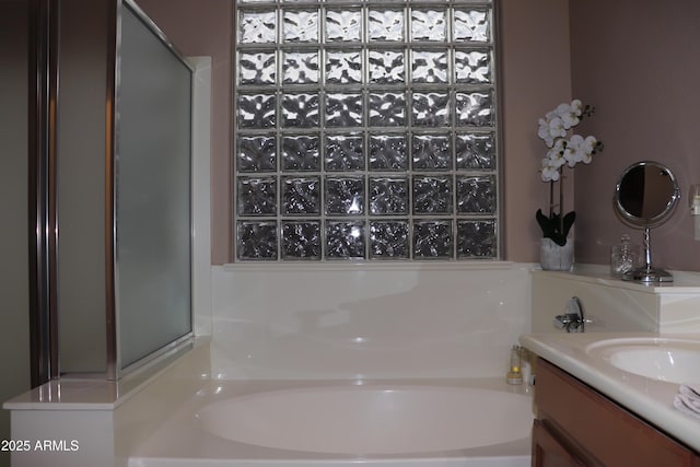 bathroom with vanity and a tub