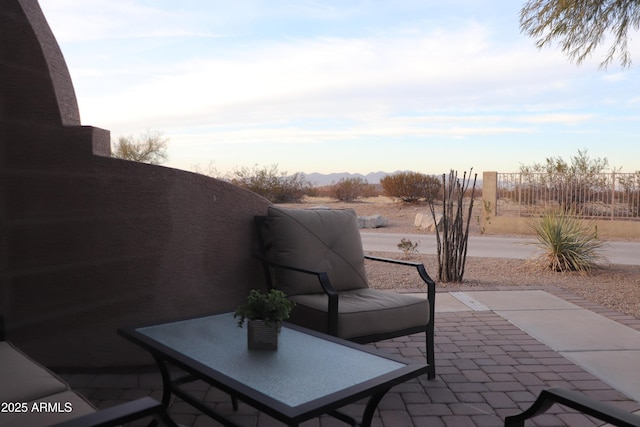 view of patio featuring fence and a mountain view