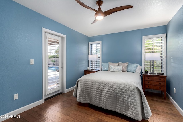 bedroom featuring access to exterior, multiple windows, and wood-type flooring