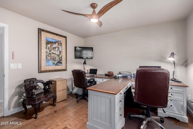 office featuring wood finished floors, baseboards, and ceiling fan