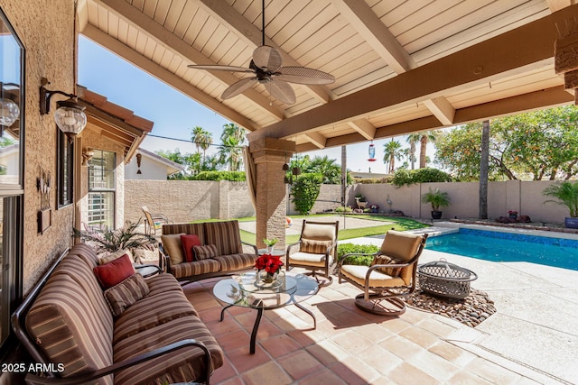 view of patio / terrace with a fenced in pool, an outdoor living space with a fire pit, a fenced backyard, and a ceiling fan