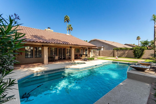 view of swimming pool with a patio, fence, and a fenced in pool